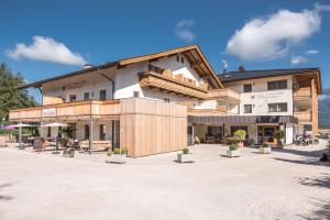 a large building with a courtyard in front of it at Hotel B&B Feldmessner in Brunico