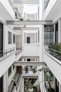 an apartment building with balconies and potted plants at Hotel Itto Condesa in Mexico City