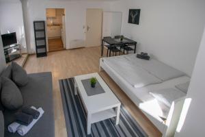 a living room with two beds and a table at Old Town Studio in Hall in Tirol