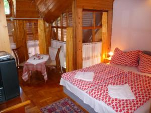 a bedroom with a bed and a table with a small table sidx sidx at Oleander B&B in Siófok