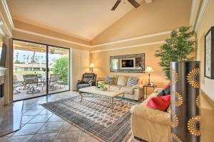 a living room with a couch and a table at Upscale Palm Desert Escape with Patio and Shared Pool! in Palm Desert