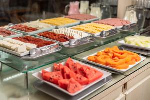
a buffet of different types of desserts on a counter at Rede Andrade Plaza Salvador in Salvador
