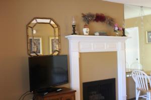 a living room with a television and a fireplace at Gatlinburg Chateau Condo 407 in Gatlinburg