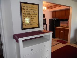 a kitchen with a white dresser with a sign on the wall at Oak Square 309 in Gatlinburg