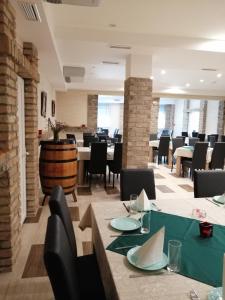 a restaurant with tables and chairs and a wine barrel at Vaš Kutak - Sobe Lux za izdavanje in Obrenovac