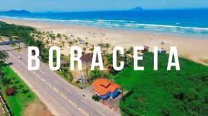 an aerial view of a beach with the word rocca at Casa em frente à praia Boracéia in Boracéia