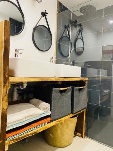 a bathroom with a sink and two mirrors at la P’tite Grange in La Cotinière +56 photos