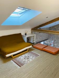 a bedroom with a bed and a desk in a attic at la P’tite Grange in La Cotinière