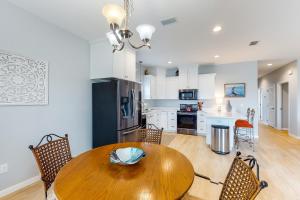 a kitchen and dining room with a wooden table and chairs at Knot a Care in Mexico Beach