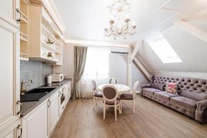 a kitchen and living room with a table and a couch at VIP apartment on Duhnovicha street .Free parking. in Uzhhorod