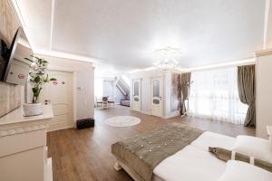 a white bedroom with a large bed in a room at VIP apartment on Duhnovicha street .Free parking. in Uzhhorod