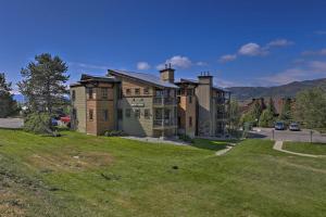 a large house on top of a grassy hill at Steamboat Springs Studio Less Than 1 Mi to Ski Resort in Steamboat Springs