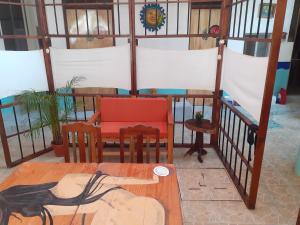 a dining room with a table and chairs in a room at Hotel Hostal Teresa in Zipolite