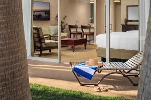 a hotel room with a bed and a table with a hat at Bahia Resort Hotel in San Diego