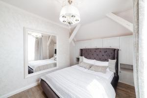 a bedroom with a bed and a mirror at LUX apartment on Duhnovicha street .Free parking. in Uzhhorod