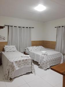 Cama ou camas em um quarto em Pousada Paraíso dos Milagres