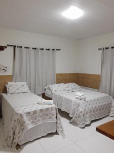 Cama ou camas em um quarto em Pousada Paraíso dos Milagres