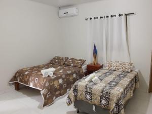 Cama ou camas em um quarto em Pousada Paraíso dos Milagres