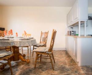 a kitchen with a table and chairs in a room at Hillview Holiday Home in Clonmany
