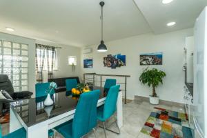 a dining room with a table and blue chairs at Bluesun Sibenik Apartments in Šibenik