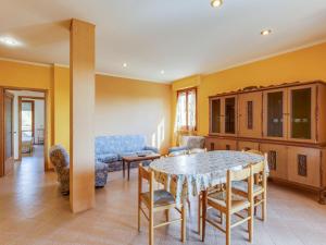 a living room with a table and a couch at Apartment in Tuscany near Lake Trasimeno in Tuoro sul Trasimeno +32 photos
