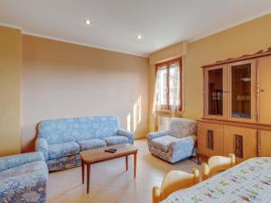 a living room with a couch and a chair at Apartment in Tuscany near Lake Trasimeno in Tuoro sul Trasimeno
