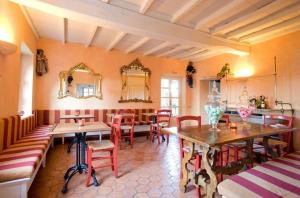 a restaurant with tables and chairs in a room at Il Paladino in Sciolze
