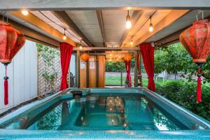 a swimming pool in a house with red lanterns at Hedgerow House in Ganges