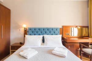 A bed or beds in a room at OPERA BLUE Hotel Gouvia Corfu
