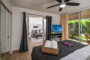 een slaapkamer met een bed en een woonkamer bij 1 BD King Suite: 40% OFF, Beach Walk in Wailea