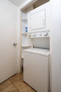 a white washer and dryer in a small kitchen at 1 BD King Suite: 40% OFF, Beach Walk in Wailea