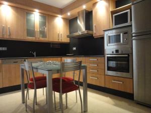 a kitchen with a table and chairs in it at Casa de Xerta in Xerta