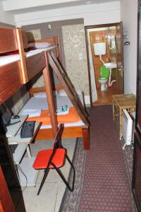 a small room with a bunk bed and a bathroom at Tash Inn Hostel in Belgrade
