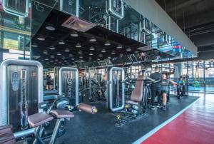 a gym with cardio equipment and people in it at Ramada Plaza by Wyndham Nanxun in Huzhou
