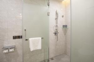 a bathroom with a shower with a glass door at Ramada Plaza by Wyndham Nanxun in Huzhou