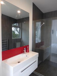 a bathroom with a white sink and a shower at Sea La Vie - Waiheke Island Luxury Accommodation in Onetangi