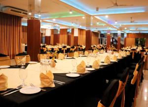 a large banquet hall with long tables and chairs at Hotel Aradhana in Galle