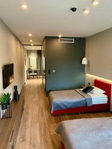 a bedroom with two beds and a green wall at Aparts Hotel Radom in Radom