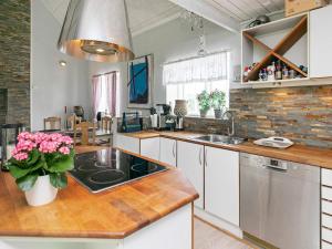 A kitchen or kitchenette at 6 person holiday home in L kken