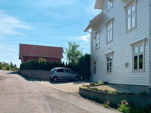 a car parked in a parking lot next to a house at 8 person holiday home in LIND S in Lindås