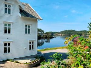 a white house with a view of a lake at 8 person holiday home in LIND S in Lindås
