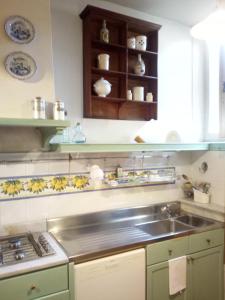 a kitchen with a sink and a stove at B&B Palazzo Bianchi in Parma