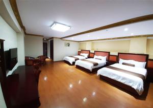 a hotel room with three beds and a television at Swan Hotel in Lima +23 photos