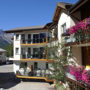 un edificio con fiori sui balconi di Apartments Alpenrose a Saas-Almagell