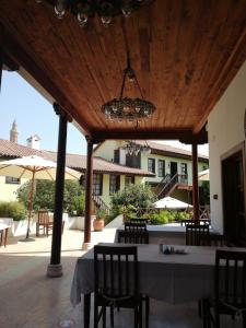 a patio area with a patio table and chairs at Tekeli Konaklari in Antalya