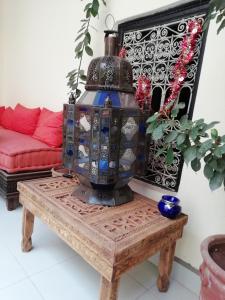 a living room with a table with a lantern on it at Riad JEREMY in Marrakech