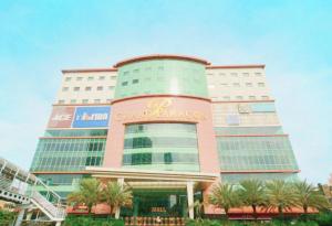 a large building with a sign on it at Grand Paragon Hotel in Jakarta