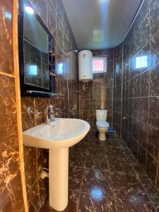 a bathroom with a sink and a toilet at Beliy Dom in Kvariati +155 photos
