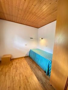 A bed or beds in a room at Residence Tarvisio Camporosso