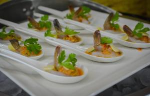 a row of appetizers in white dishes on a tray at TRYP by Wyndham Abu Dhabi City Center in Abu Dhabi
